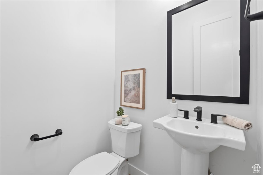 Bathroom featuring toilet and baseboards