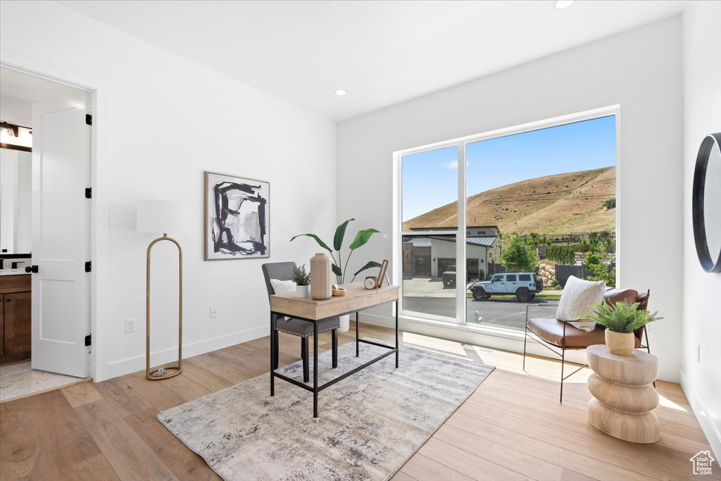 Office area with light wood-style flooring, recessed lighting, and a mountain view