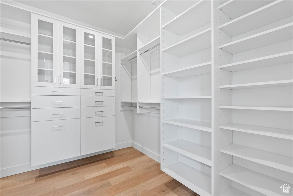 Walk in closet featuring light wood-type flooring