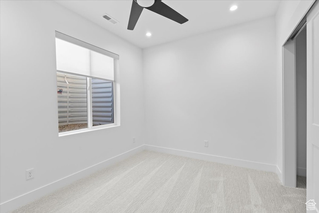 Unfurnished bedroom featuring light colored carpet, recessed lighting, and a ceiling fan