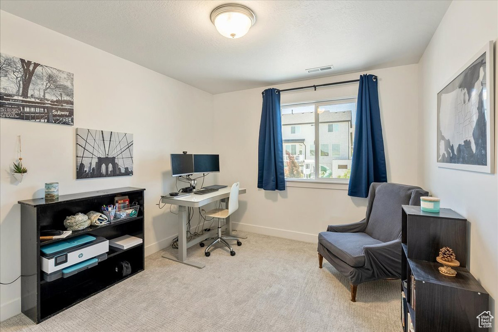 Carpeted home office with baseboards