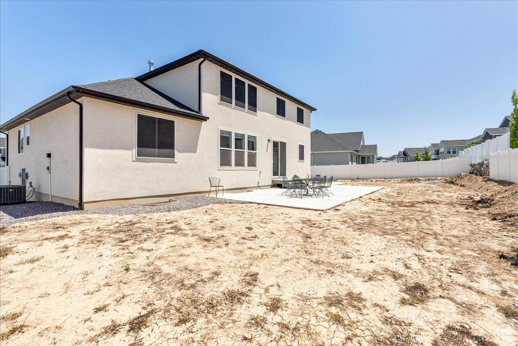 Rear view of house featuring a patio, a fenced backyard, and stucco siding