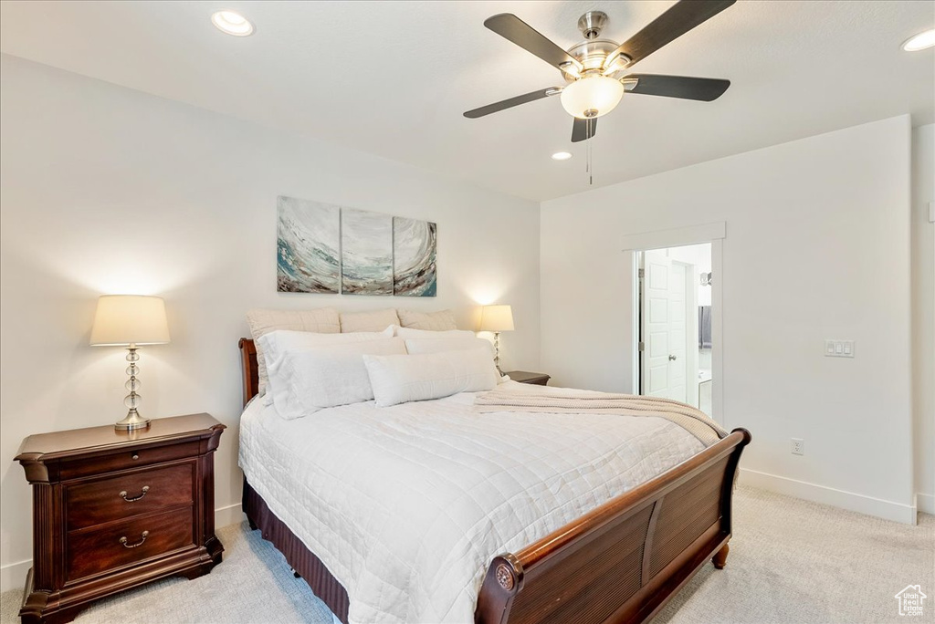 Bedroom with light colored carpet, recessed lighting, ensuite bath, and a ceiling fan