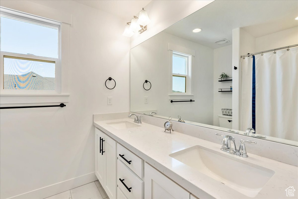 Full bathroom featuring double vanity and recessed lighting