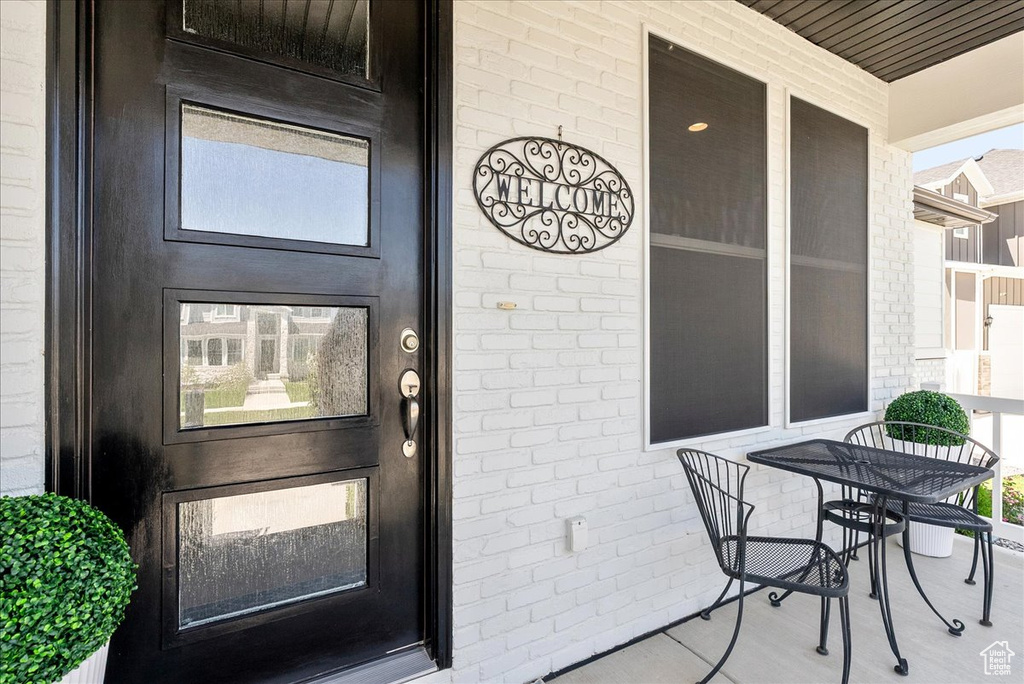 View of exterior entry featuring brick siding