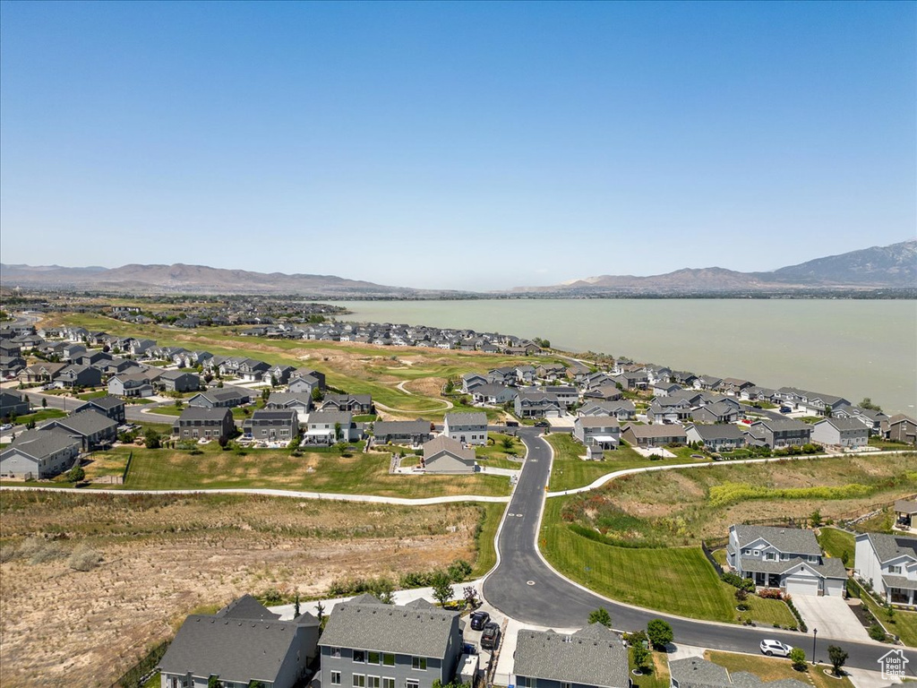 Aerial overview of property\'s location featuring nearby suburban area and a water and mountain view