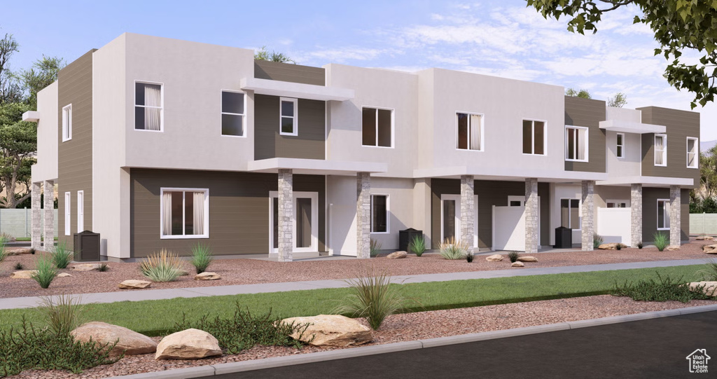 View of front facade with stucco siding and stone siding