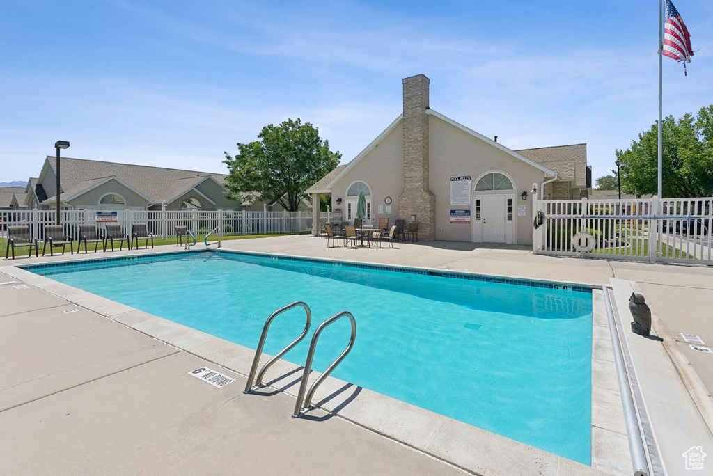 Community pool with a patio