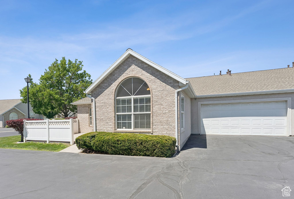 Ranch-style home with driveway and an attached garage