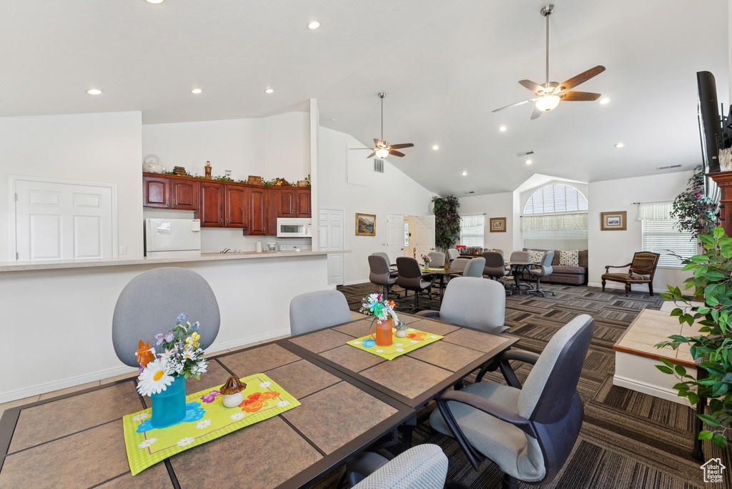 Dining room featuring ceiling fan, high vaulted ceiling, and recessed lighting
