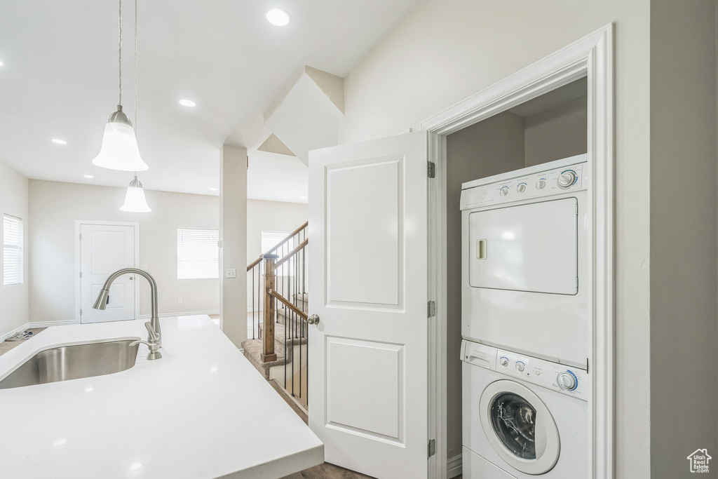 Washroom with stacked washer and clothes dryer, healthy amount of natural light, and recessed lighting