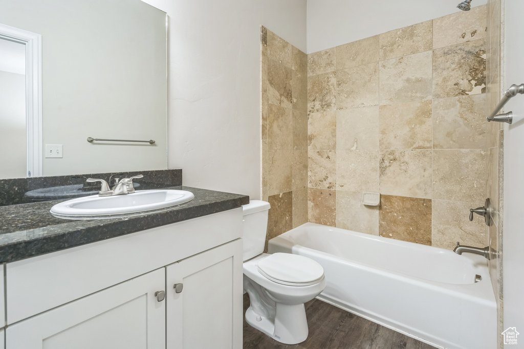 Full bathroom featuring vanity, shower / bathtub combination, and wood finished floors