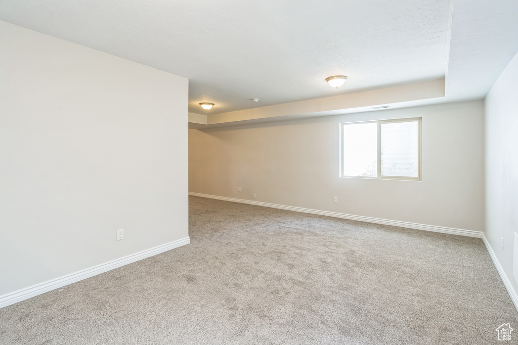Carpeted empty room with baseboards