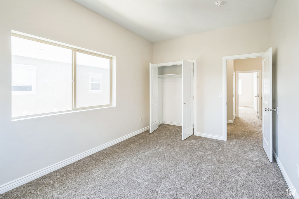 Unfurnished bedroom with carpet floors and a closet