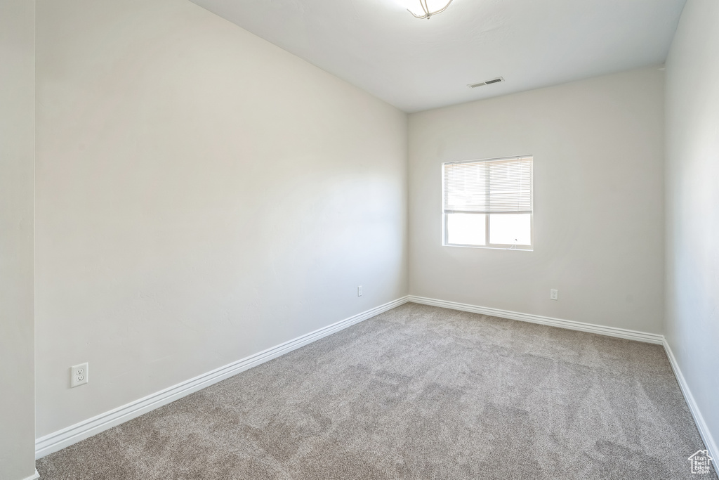 Empty room with carpet and baseboards