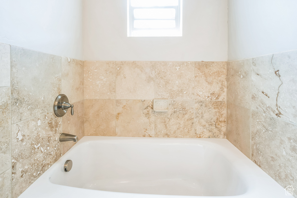 Full bath featuring a bath