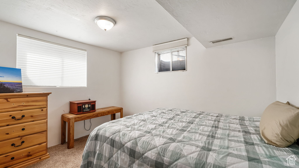 Bedroom featuring light colored carpet