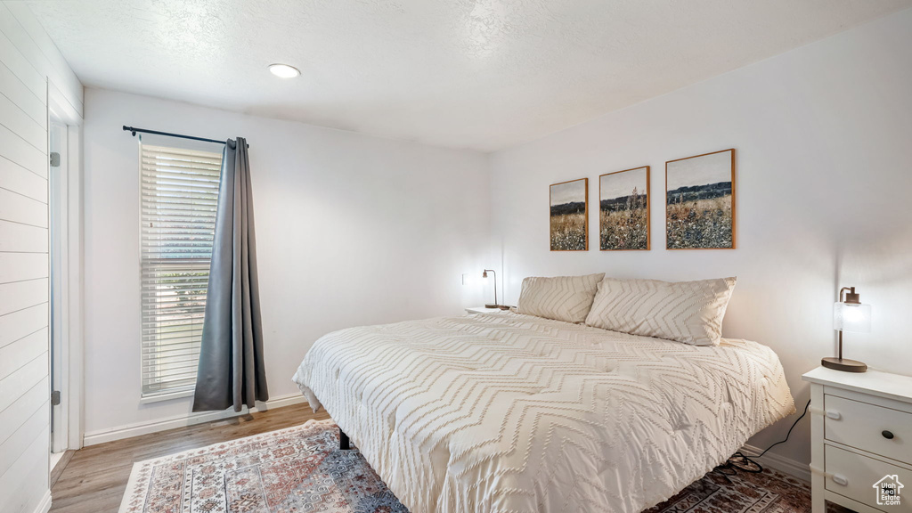 Bedroom with light wood-type flooring and recessed lighting