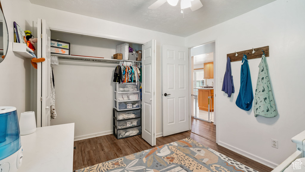 Bedroom featuring wood finished floors, a closet, and ceiling fan