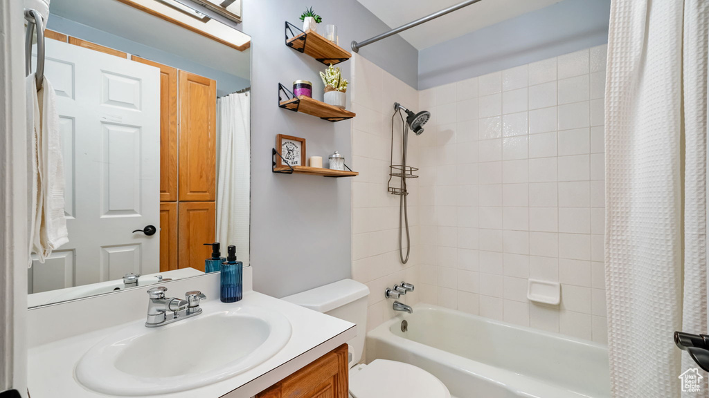Full bathroom featuring vanity and shower / tub combo with curtain