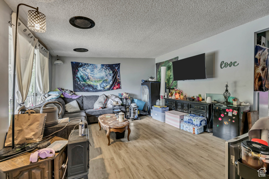 Living area featuring a textured ceiling and wood finished floors