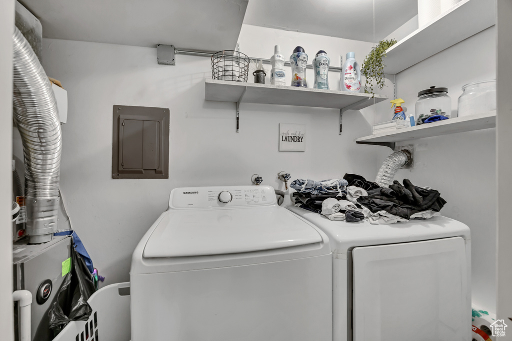 Laundry room with separate washer and dryer and electric panel