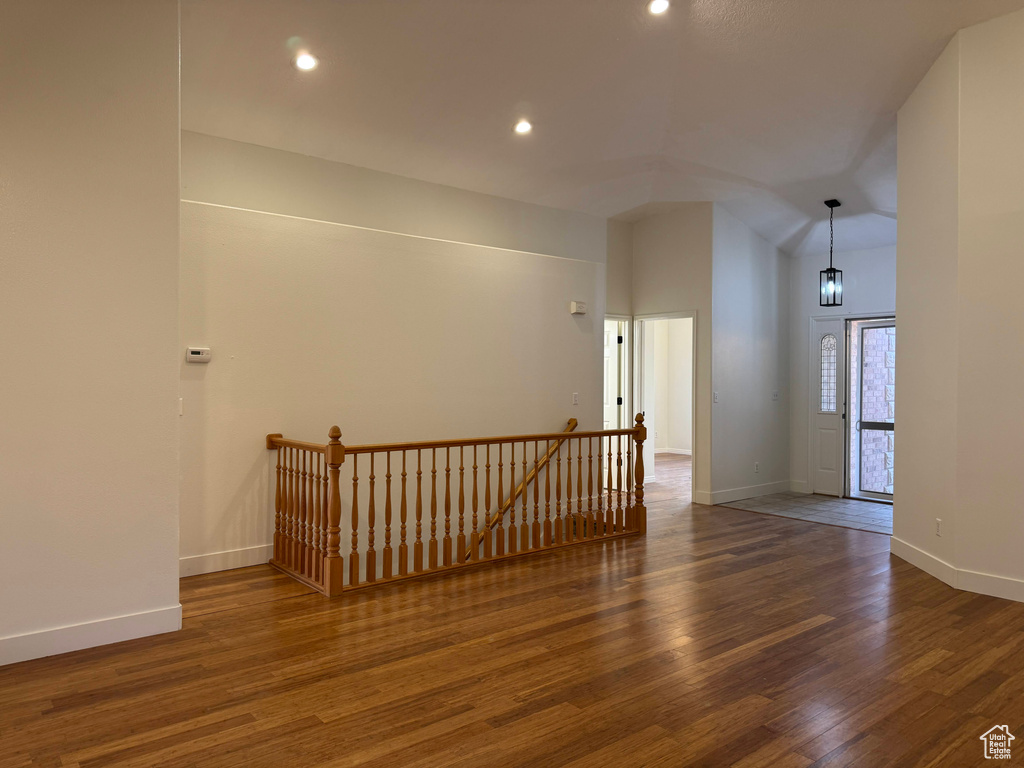 Empty room featuring wood finished floors, recessed lighting, and vaulted ceiling