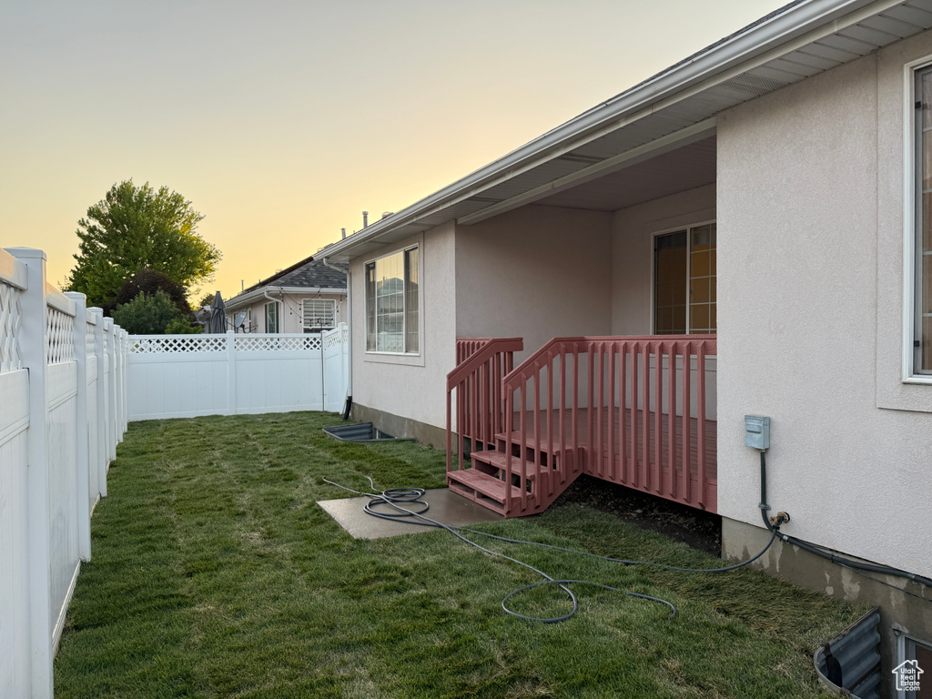 Yard at dusk with a fenced backyard