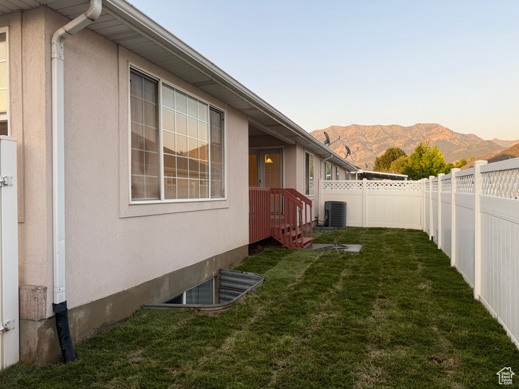 Fenced backyard featuring a mountain view