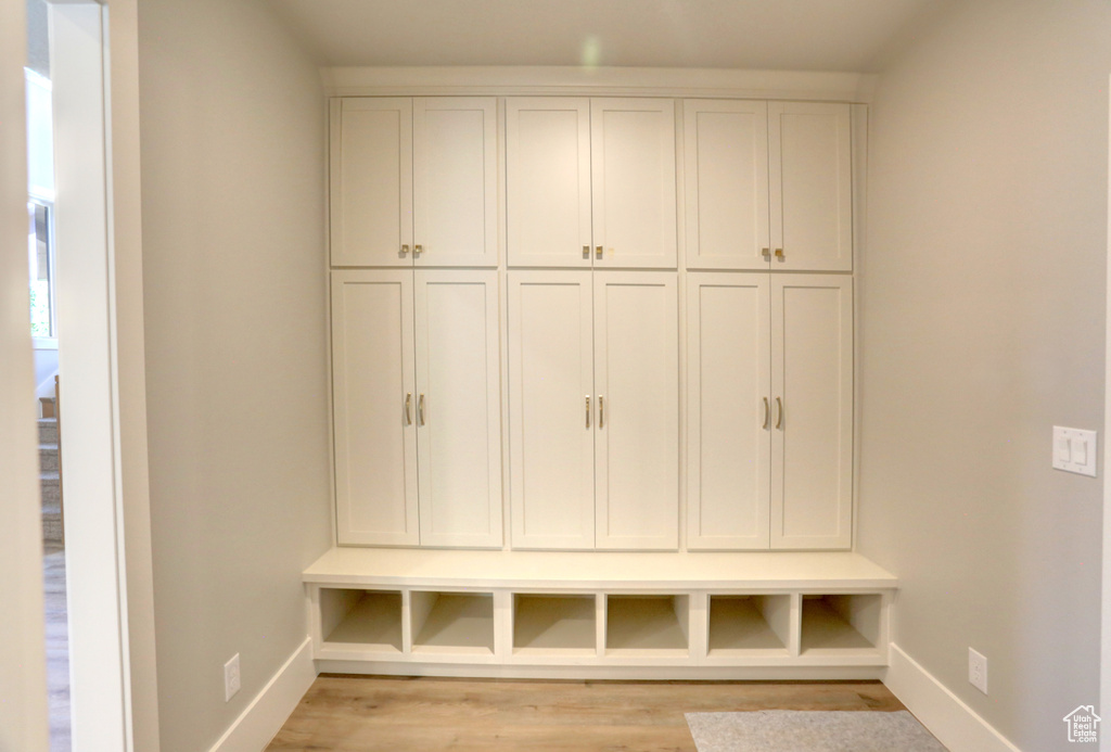 Mudroom with baseboards and light wood-style floors