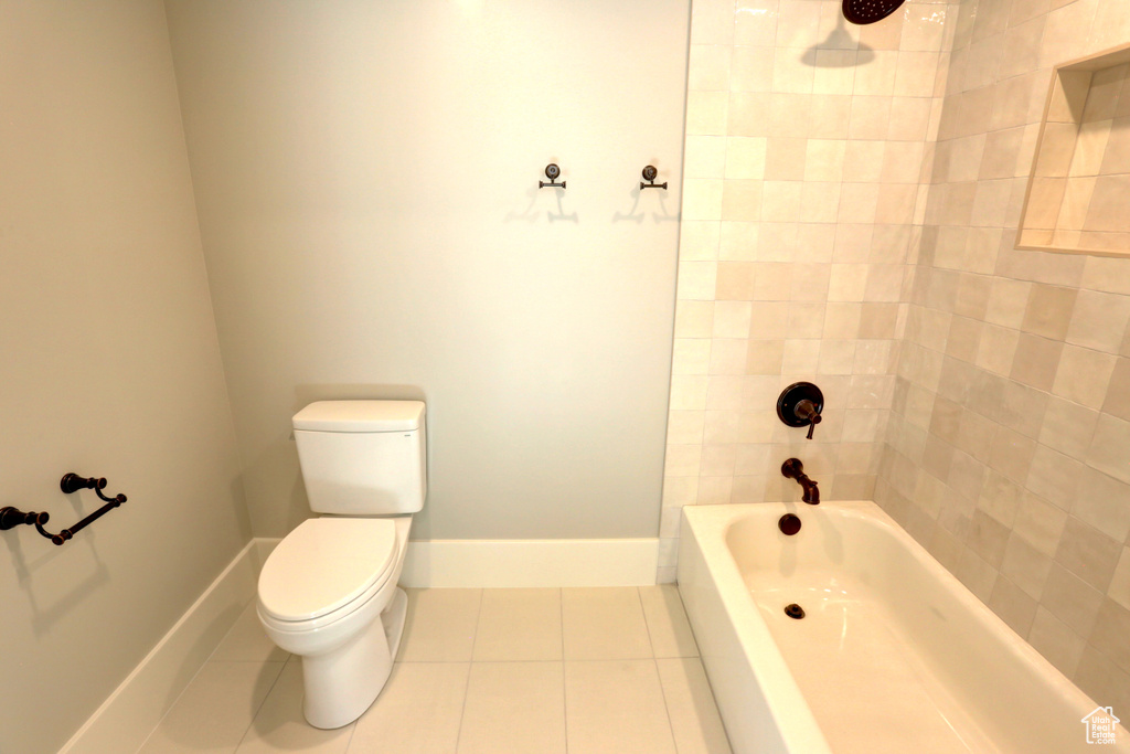 Full bath featuring tile patterned flooring and shower / tub combination