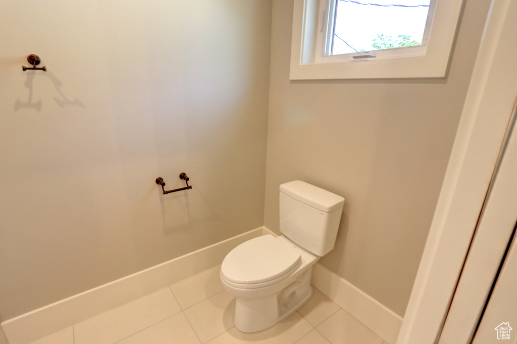 Bathroom featuring toilet and tile patterned flooring
