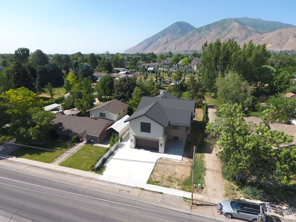 Aerial view of property and surrounding area with a mountainous background