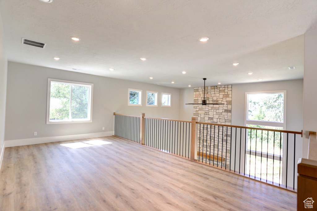 Empty room with wood finished floors and recessed lighting