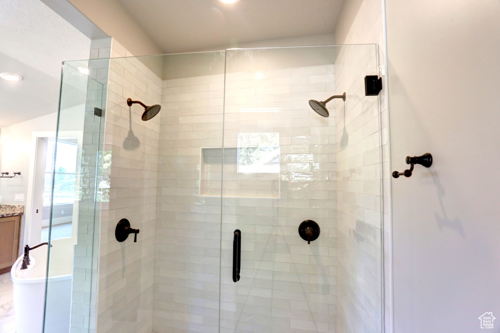 Bathroom featuring a shower stall and vanity