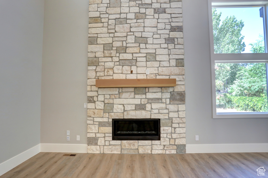 Detailed view of wood finished floors and a fireplace