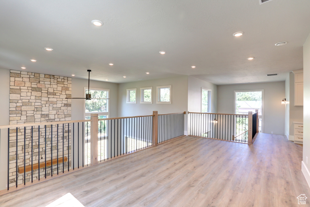 Unfurnished room with wood finished floors and recessed lighting