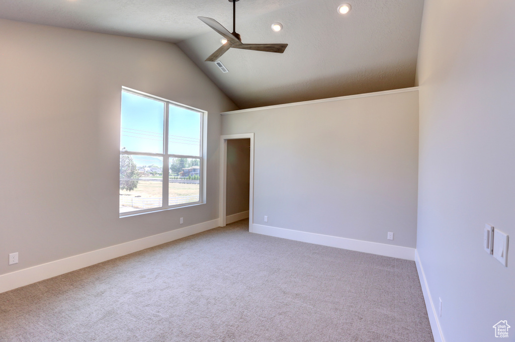 Unfurnished room with ceiling fan, light carpet, lofted ceiling, and recessed lighting