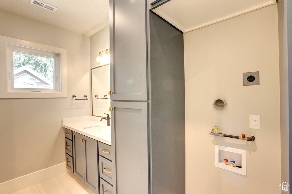 Bathroom featuring vanity and tile patterned floors