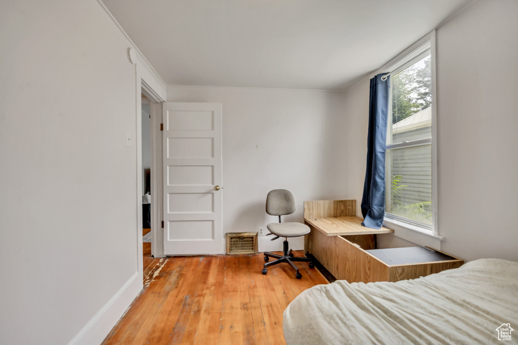 Bedroom with multiple windows and light wood-type flooring