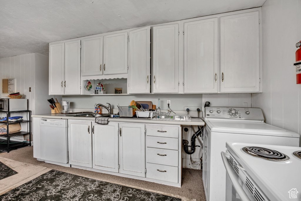 Kitchen with white appliances, white cabinets, light countertops, and open shelves
