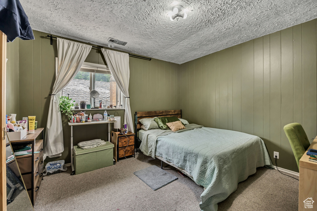 Bedroom with carpet and a textured ceiling