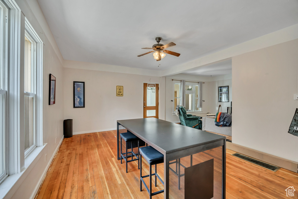 Dining room with a ceiling fan and light wood-type flooring