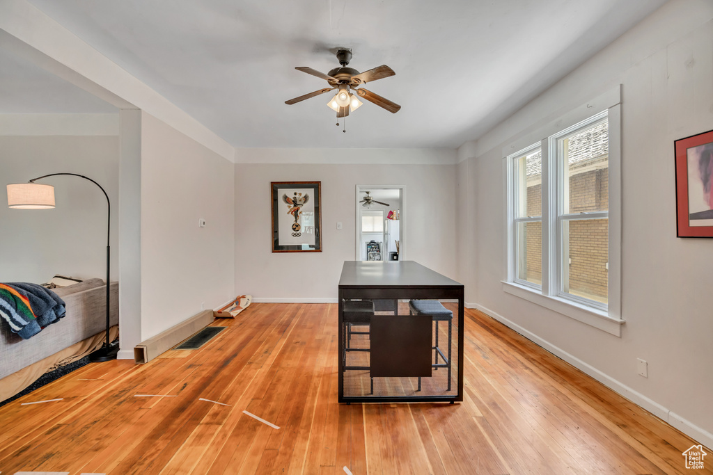 Dining room with a ceiling fan and light wood finished floors
