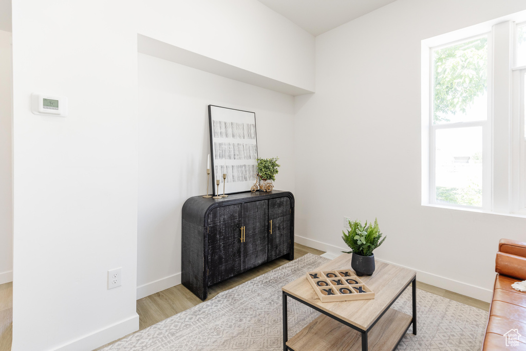 Living area with light wood finished floors and baseboards