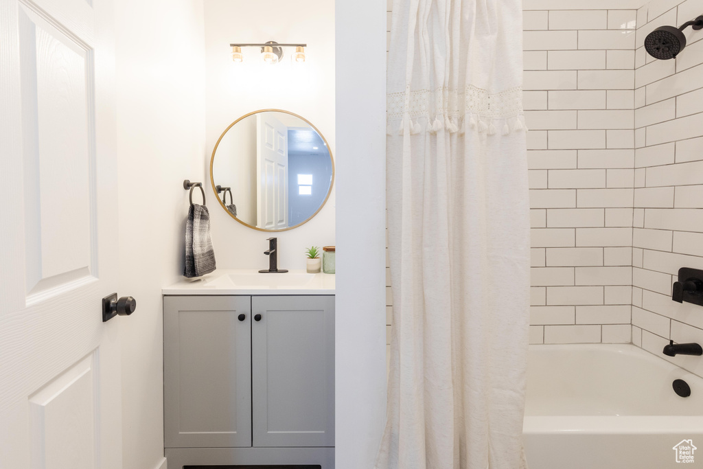 Full bath featuring vanity and shower / bath combination with curtain