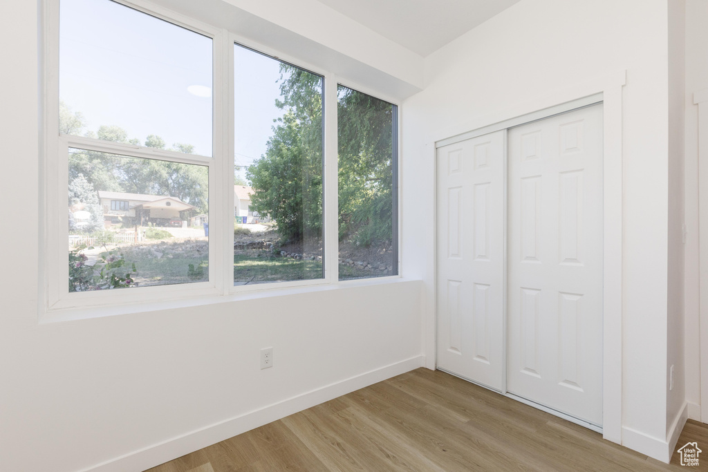 Unfurnished bedroom featuring light wood-type flooring and a closet