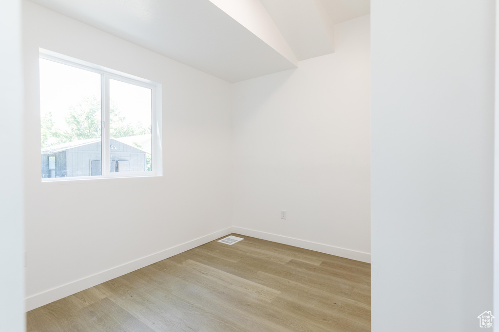 Spare room with light wood-style floors and baseboards