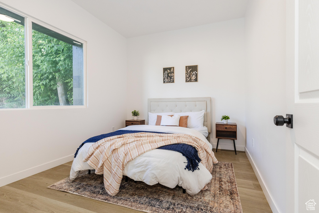 Bedroom with light wood finished floors and baseboards