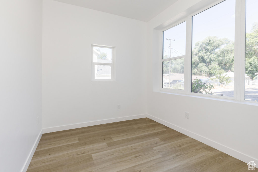 Spare room with light wood-type flooring and baseboards